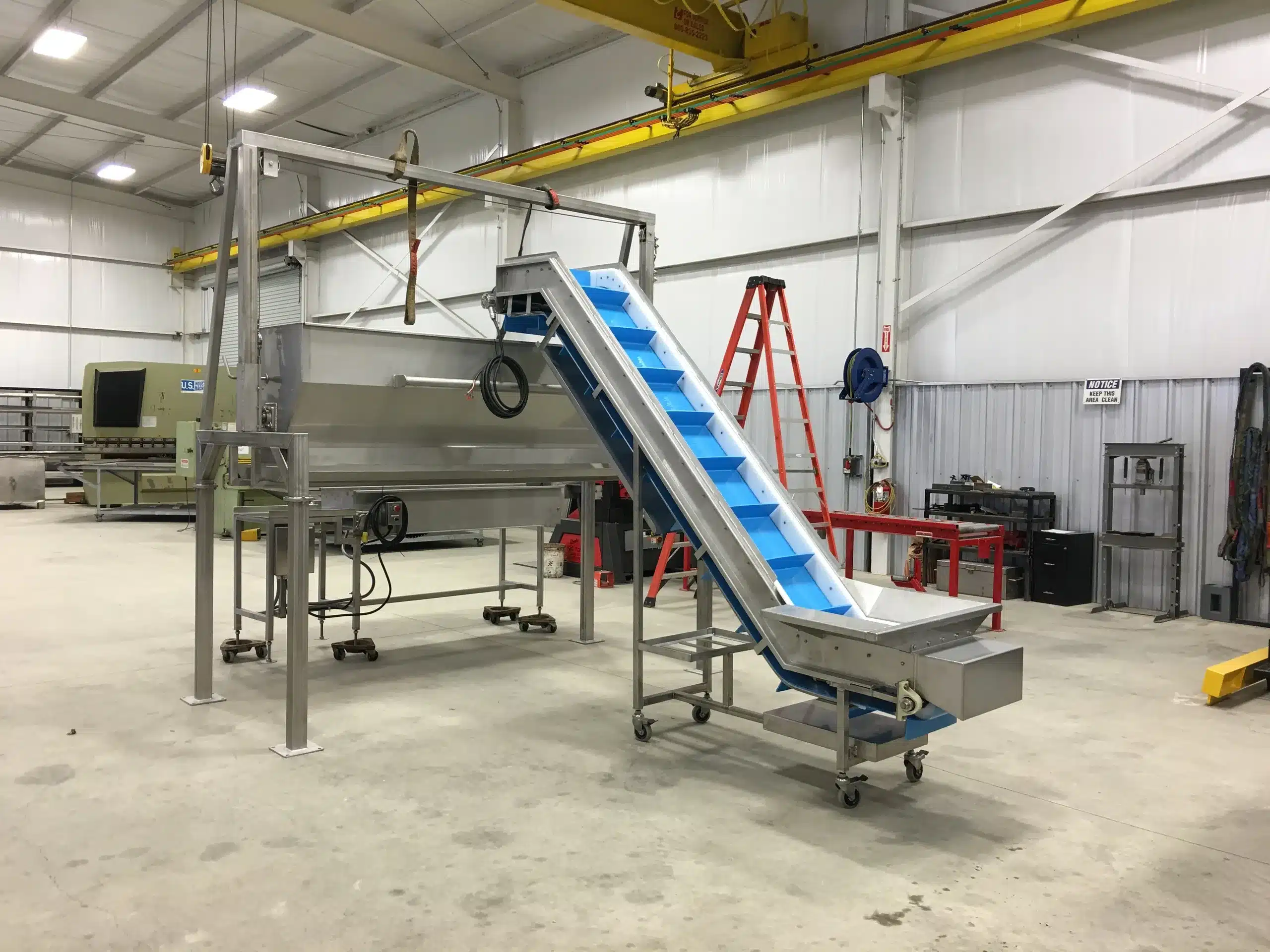 Custom blue belt conveyor built by Second Generation Arc 'N' Spark